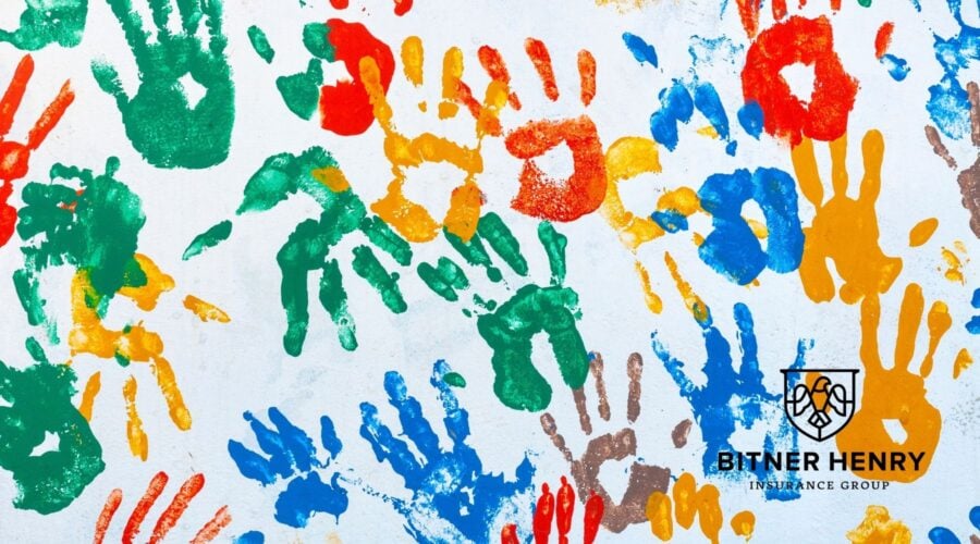 Children's ministry handprints on a wall. The Bitner Henry logo is in the bottom right.