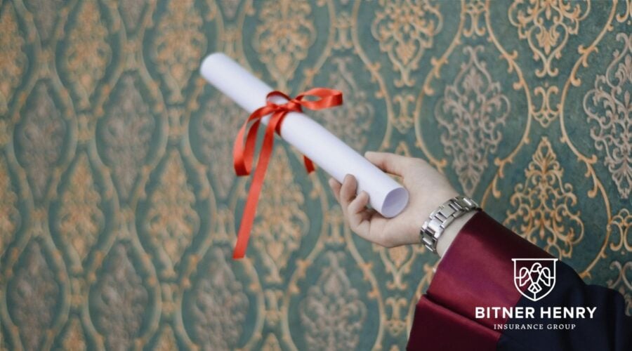 someone holds onto a certificate of insurance. The Bitner Henry logo is in the bottom right.