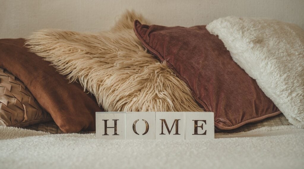 comfy, homey pillows in a group home. A decal says 