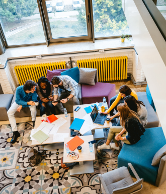 A bunch of people in a group home laugh and have fun together, doing things