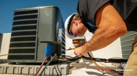 An HVAC contractor fixes an air conditioner