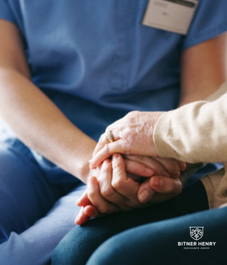 A detox nurse holds her patient's hand