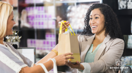 a retailer hands a customer or a supplier a bag