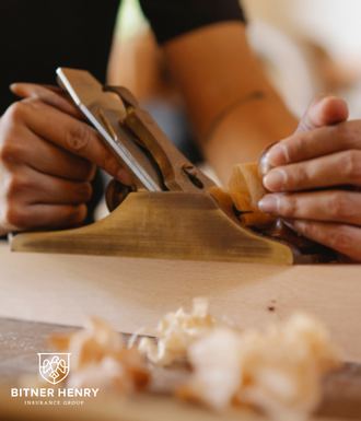 A man shaves the wood shavings off of the wood.