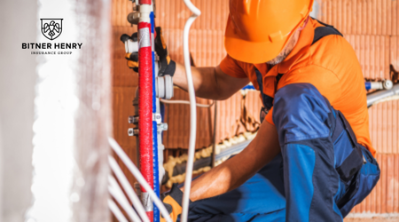 A plumber fixes pipes, with the Bitner Henry logo in the top left.