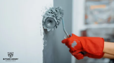 A painter uses a roller to paint the walls