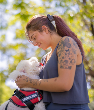 A human services employee walks a dog.