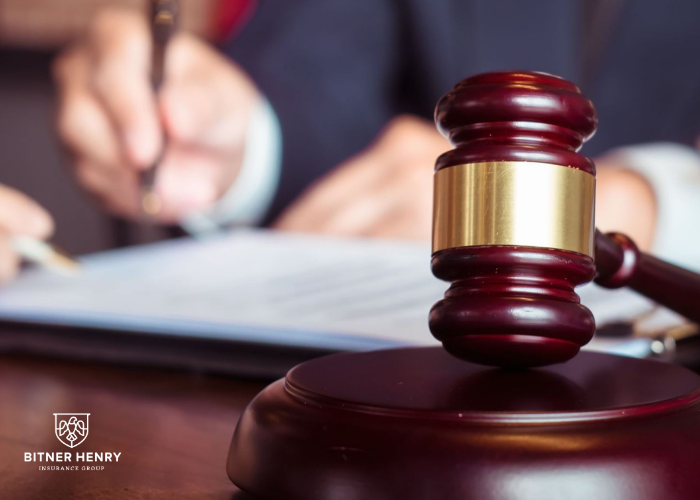 a gavel and a legal pad, with a judge ready to decide. The Bitner Henry logo is in the bottom right.