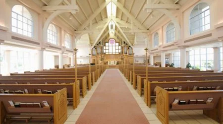 The inside of a church, featuring pews, glass, and more