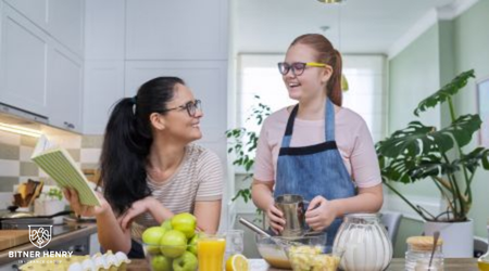 Two people- a recovery patient and a helper- cook together in the kitchen.