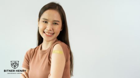 A recovering woman with a bandage on her arm smiles