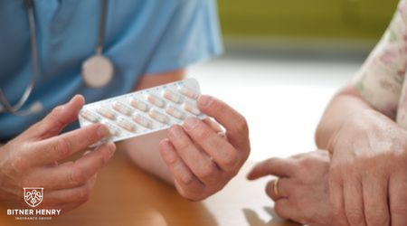 Someone helps a recovery patient with their pills