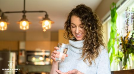 A woman takes medication as part of treatment