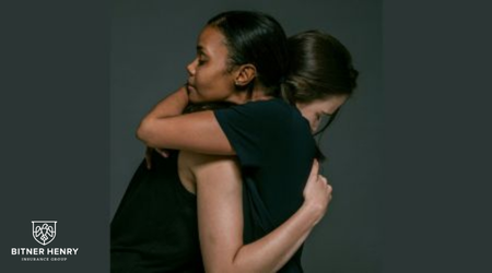 A woman hugs a recovery patient