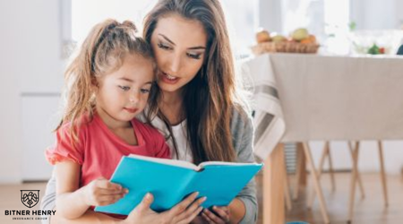 A mom reads to her daughter as they homeschool from curriculum