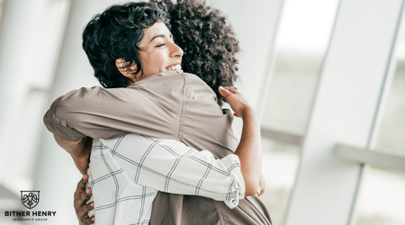Two people embrace each other, healing