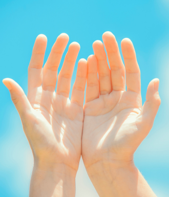 Someone raises their hands in therapy for healing